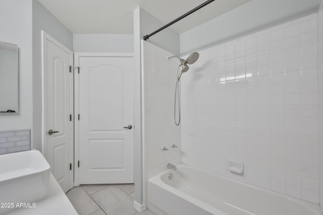 bathroom with washtub / shower combination, tile patterned flooring, and a textured ceiling