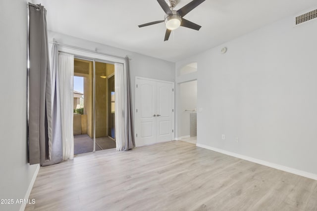 unfurnished room with light wood-style floors, visible vents, ceiling fan, and baseboards