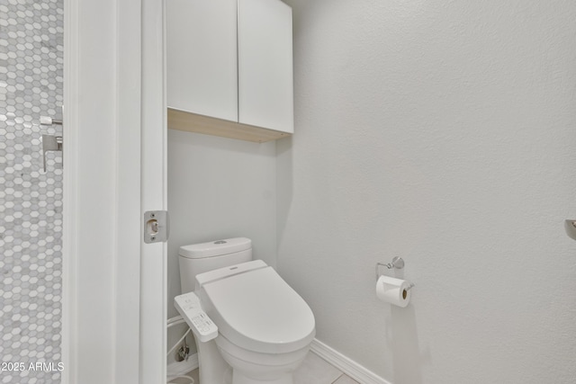 bathroom featuring toilet and baseboards