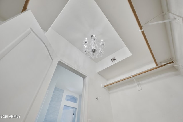 details featuring an inviting chandelier and visible vents