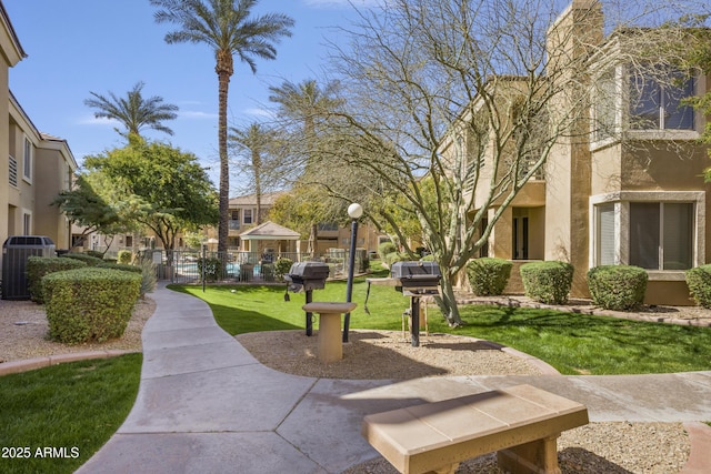 view of home's community featuring fence and a lawn