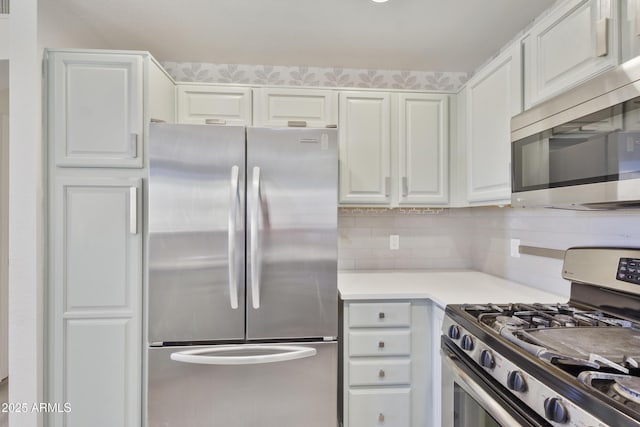 kitchen with white cabinetry, appliances with stainless steel finishes, and light countertops