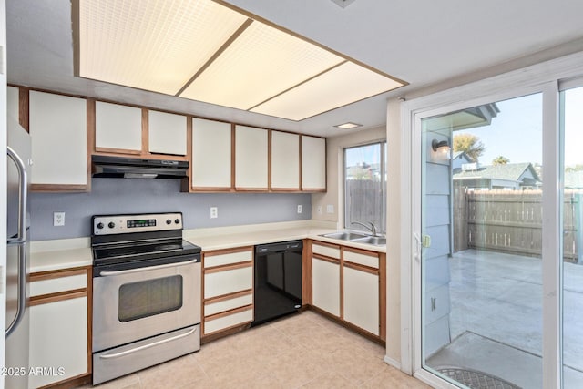 kitchen featuring white cabinetry, appliances with stainless steel finishes, sink, and light tile patterned floors