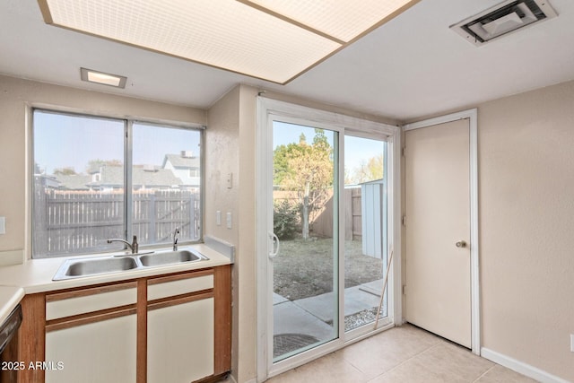 entryway featuring light tile patterned flooring and sink