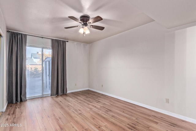 empty room with light hardwood / wood-style flooring and ceiling fan