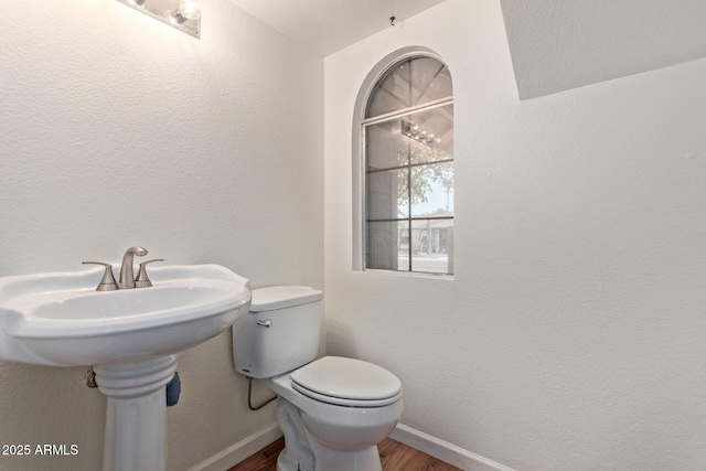 bathroom featuring hardwood / wood-style floors and toilet