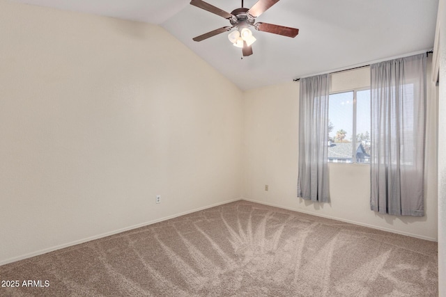 spare room featuring carpet floors, vaulted ceiling, and ceiling fan