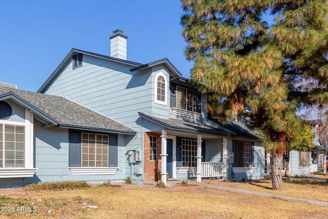 view of front facade featuring covered porch and a front yard