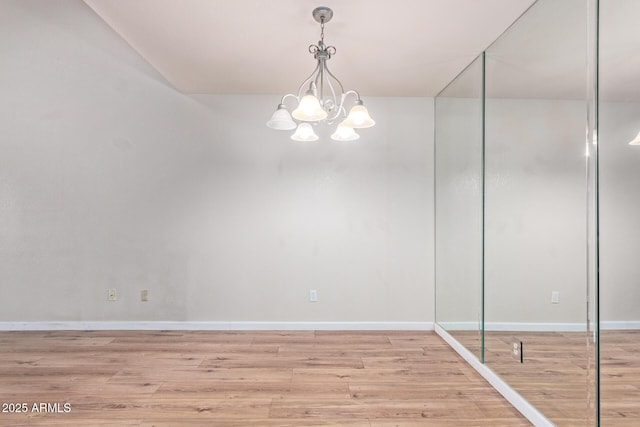 interior space with a chandelier and light hardwood / wood-style floors