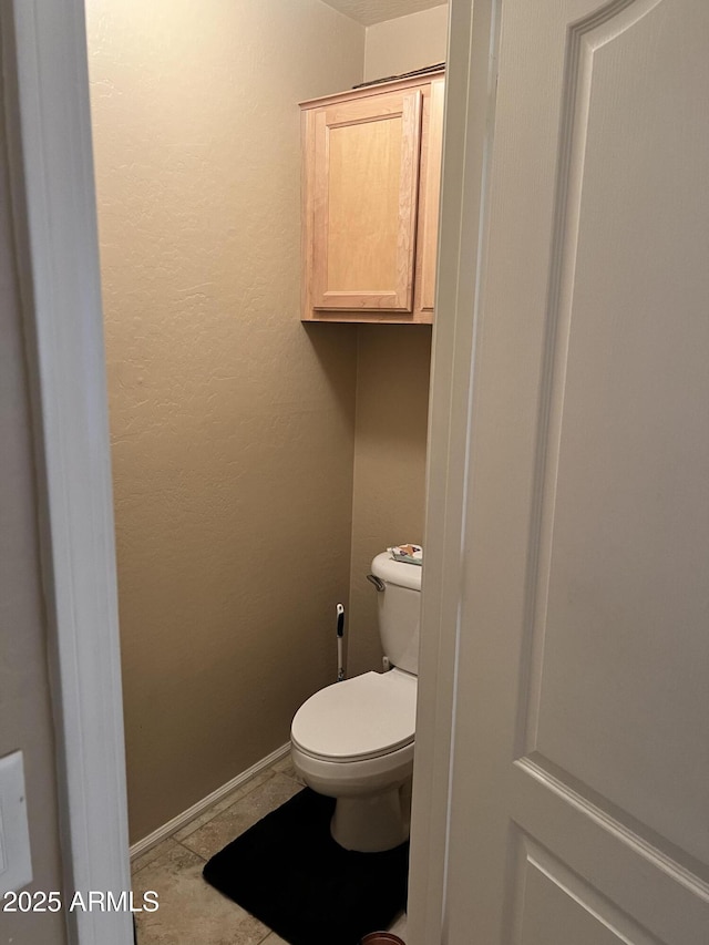 bathroom featuring tile patterned floors and toilet