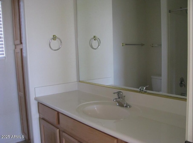 bathroom with vanity, toilet, and walk in shower