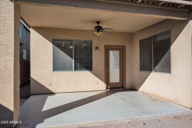 doorway to property with a patio and ceiling fan