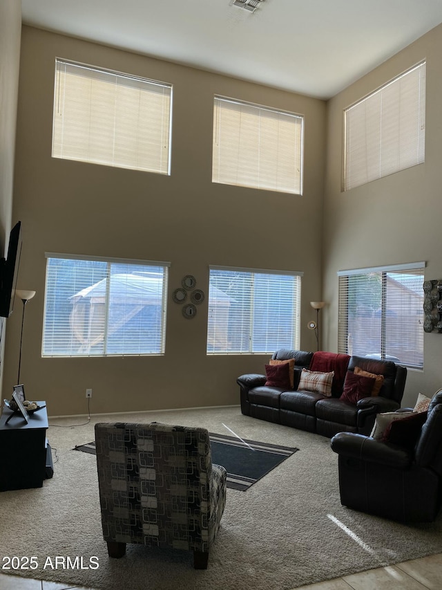 living room with carpet flooring and a high ceiling