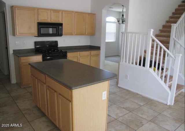 kitchen with a center island, light tile patterned floors, an inviting chandelier, and black appliances