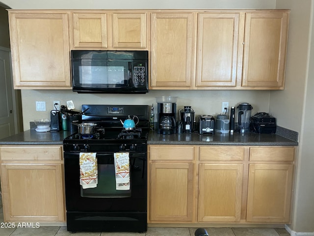 kitchen featuring light tile patterned flooring, light brown cabinets, and black appliances