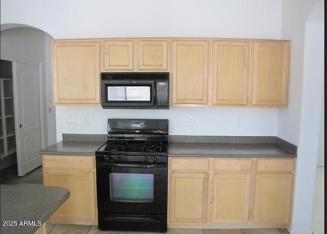 kitchen with black appliances and light brown cabinets