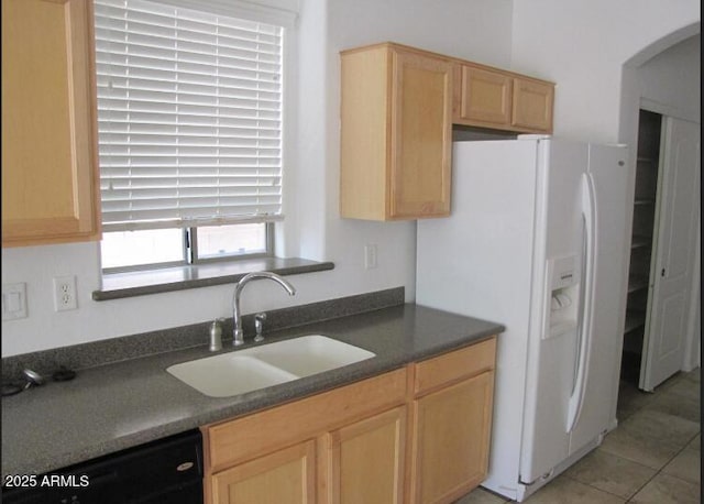 kitchen featuring sink, light tile patterned floors, light brown cabinets, black dishwasher, and white fridge with ice dispenser