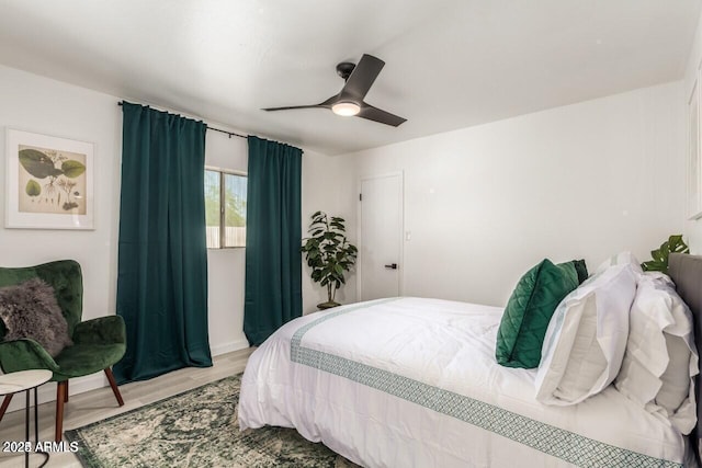 bedroom with ceiling fan and light hardwood / wood-style floors