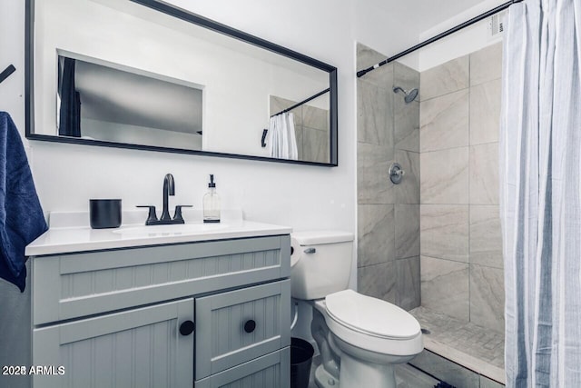 bathroom featuring walk in shower, vanity, and toilet