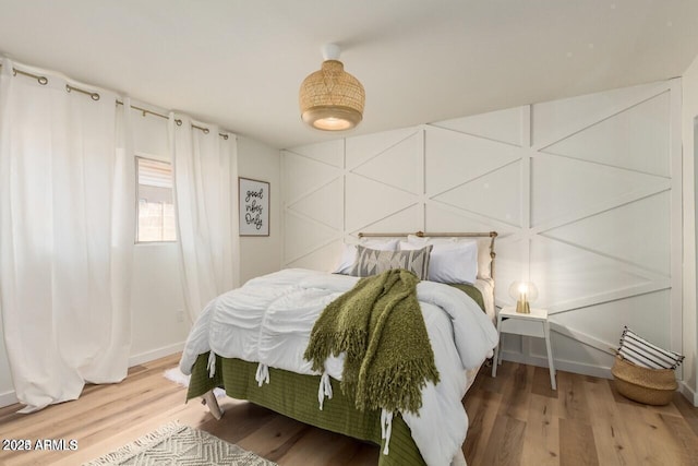 bedroom with hardwood / wood-style floors