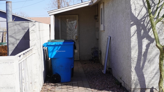 view of home's exterior featuring fence and stucco siding