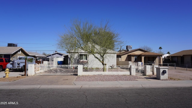 view of front of house featuring a fenced front yard, a residential view, and a gate