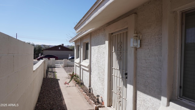 view of home's exterior featuring fence and stucco siding