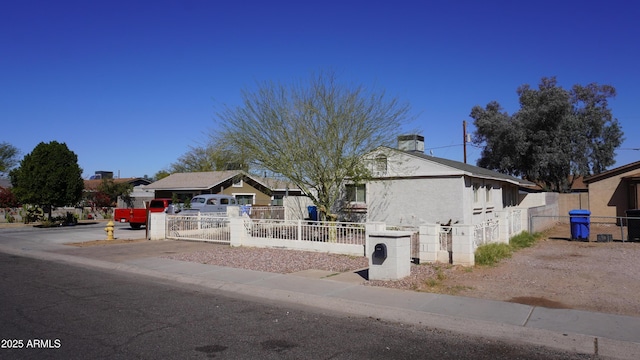 view of front facade featuring a fenced front yard and a gate