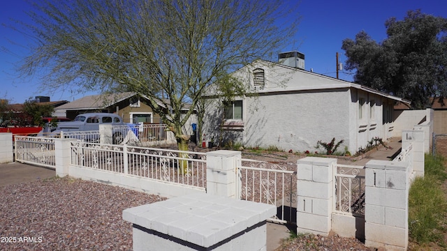 view of front of property with a gate, a fenced front yard, and stucco siding