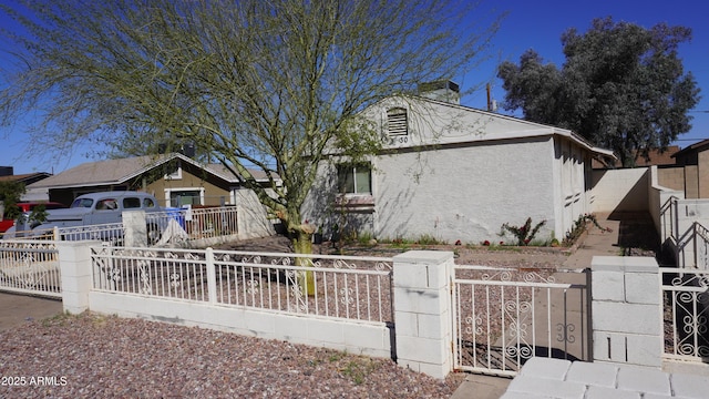 view of front of property with a fenced front yard and stucco siding