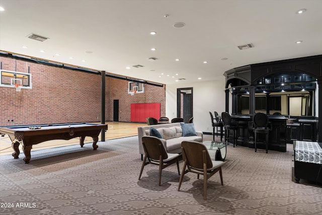 playroom featuring light carpet, bar area, brick wall, and pool table