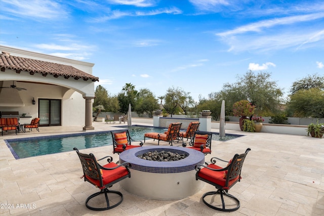 view of swimming pool featuring a patio area, area for grilling, an outdoor fire pit, and ceiling fan