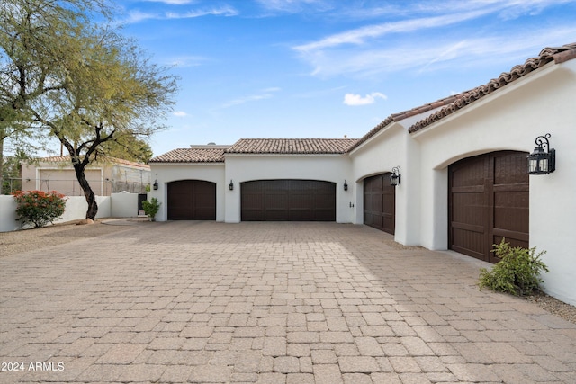 mediterranean / spanish-style home with a garage