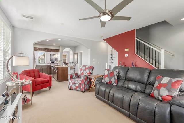 905 S Osborn Ln, Gilbert, AZ 85296 - carpeted living area with arched walkways, plenty of natural light, ceiling fan, and stairs