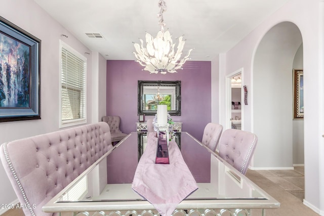 905 S Osborn Ln, Gilbert, AZ 85296 - dining area with a chandelier, arched walkways, and tile patterned floors