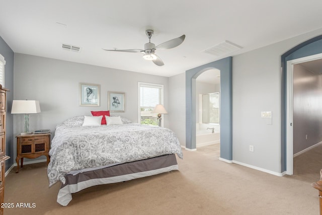 905 S Osborn Ln, Gilbert, AZ 85296 - bedroom featuring arched walkways, light carpet, ceiling fan, and ensuite bathroom