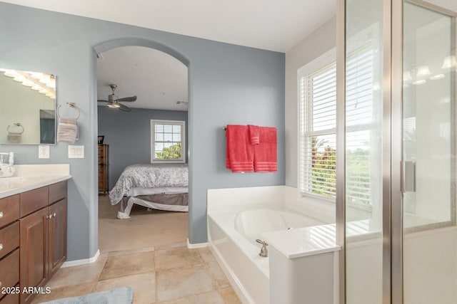 905 S Osborn Ln, Gilbert, AZ 85296 - ensuite bathroom with vanity, a bath, a ceiling fan, and a shower with shower door
