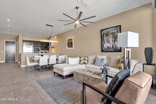 living room with light tile floors and ceiling fan