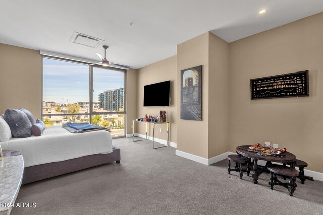 carpeted bedroom featuring floor to ceiling windows