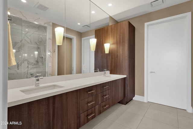 bathroom with walk in shower, tile floors, oversized vanity, and dual sinks