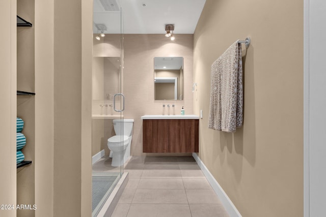 bathroom with oversized vanity, toilet, tile floors, and walk in shower