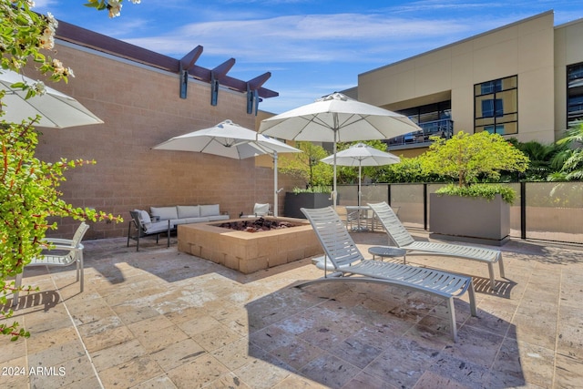 view of patio / terrace featuring an outdoor living space with a fire pit