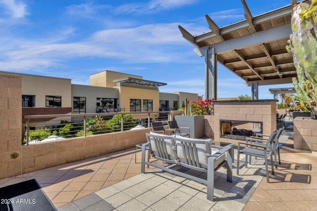 view of patio / terrace featuring a tiled fireplace