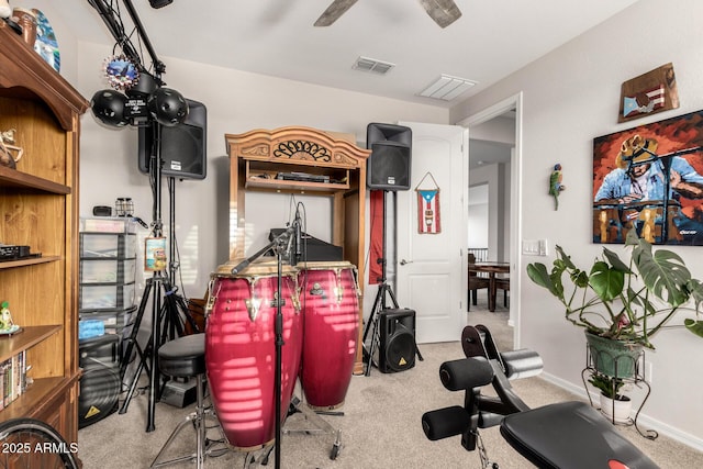 exercise room with baseboards, visible vents, and carpet flooring