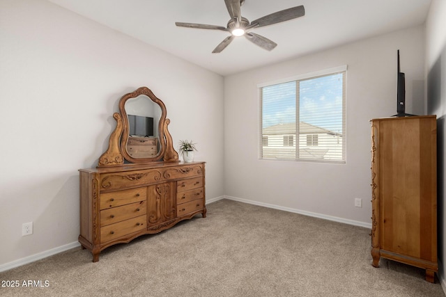 bedroom featuring baseboards, a ceiling fan, and light colored carpet