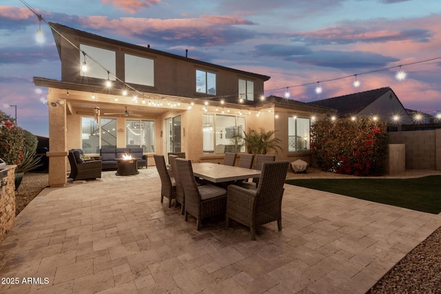 view of patio / terrace with outdoor dining space, an outdoor living space with a fire pit, and fence