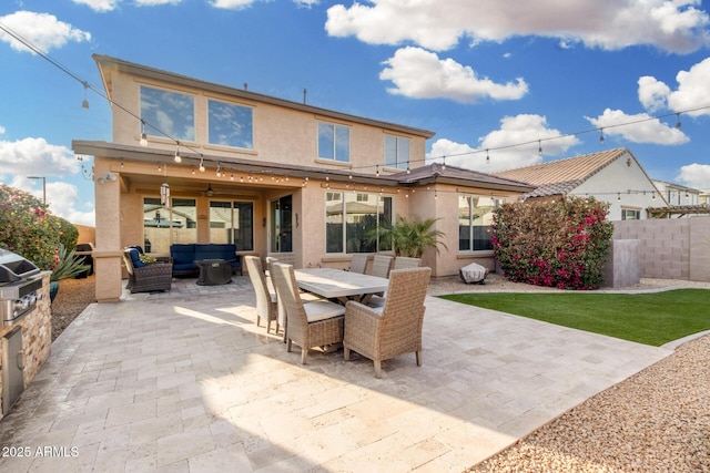 back of house featuring a patio area, outdoor dining space, outdoor lounge area, and stucco siding