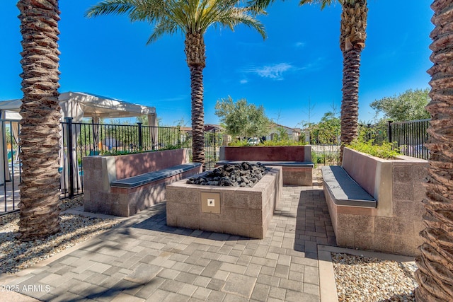 view of patio / terrace with an outdoor fire pit and fence