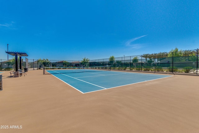 view of sport court featuring fence