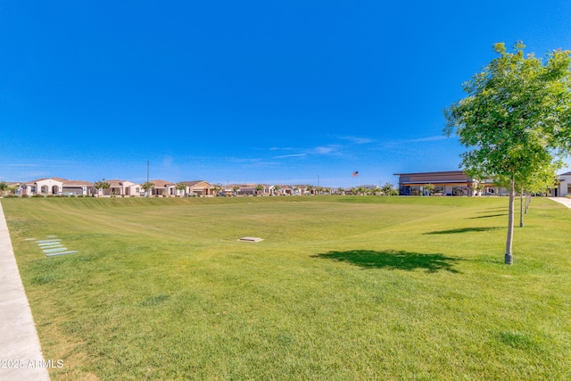 view of home's community featuring a residential view and a yard